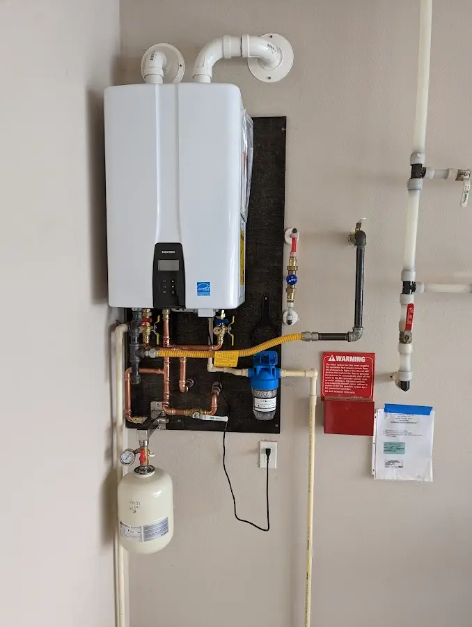 Professional plumber installing copper piping in a Fairfield Plantation home